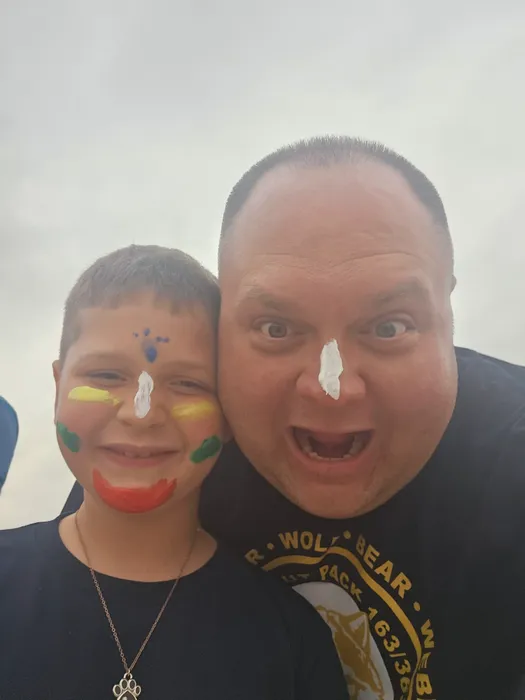 Wyatt and an adult smiling with playful face paint