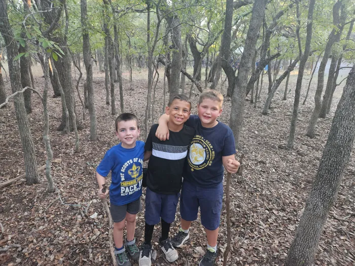 Wyatt and his friends together on a wooded trail